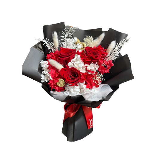 Bouquet of red and white flowers with black wrap on a white background